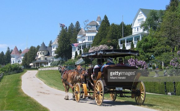 A horse-drawn carriage passes