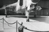 A little boy watches the Canadian-built fighter, the Avro Arrow, as it is wheeled out of its hangar in 1958 or 1959.