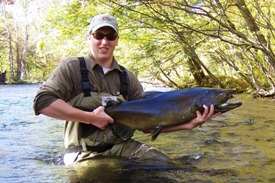 Angler with large male chinook salmon