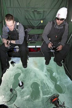 Brad Richgels (left) of Superior, Wis., and Casey Curtis of Silver Bay, Minn., jig for lake trout on Lake Superior on Tuesday afternoon, March 4, 2014, offshore from Duluth. They were among more than 50 anglers or groups of anglers fishing on the lake. (Steve Kuchera / Duluth News Tribune)