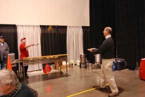 Commercial pilot Rick Titsworth is ready to receive his first flying pancake from Trevor Muir at the pancake breakfast.