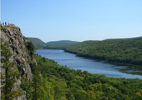 The beautiful Lake of the Clouds is surrounded by towering hills with lush green northwoods vegetation.
