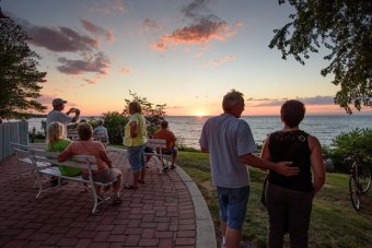 Sunset watchers gather behind the Firehouse Winery at GOTL in July to watch a sunset. The best sunsets on Lake Erie come in the late summer and early fall, when the light is lower and warmer on the horizon, and cold fronts deliver large, dramatic clouds to our doorstep.