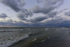 The sun was gone but the afterglow gave the shoreline an eerie feel,  punctuated by the dark clouds.