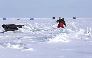 Tom Gavitt of Duluth pulls his ice-fishing sled through a pressure ridge of ice on Lake Superior on Tuesday, March 4, 2014, offshore from DuluthÃ¢â‚¬â„¢s Brighton Beach. Gavitt was one of many anglers who ventured onto the lake to fish for lake trout. (Steve Kuchera / Duluth News Tribune)